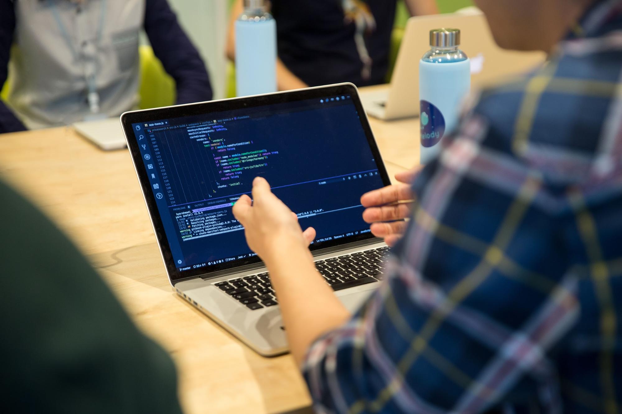 Engineers having a discussion at a meeting of the Hotel Search team Working in Hotel Search