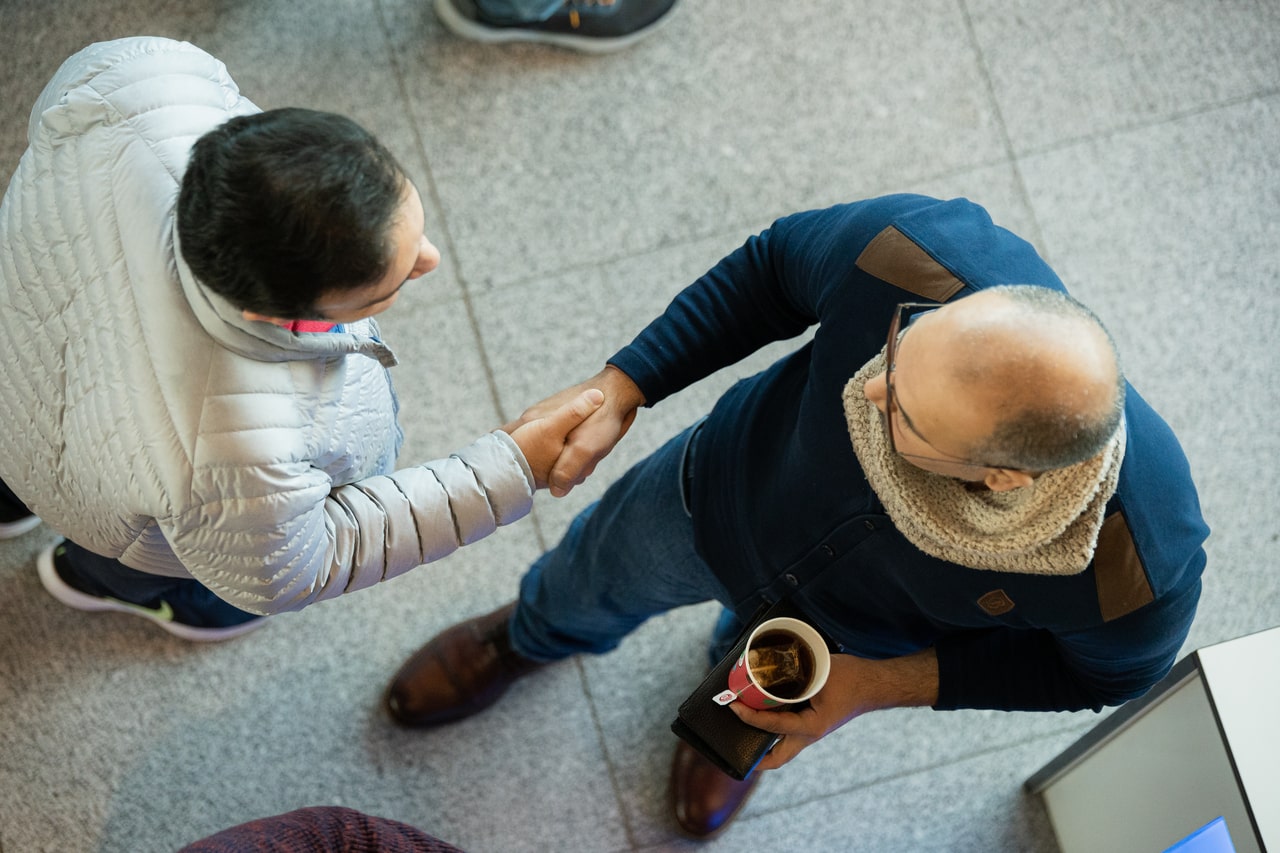 Two conference visitors shaking hands. The event was a welcome networking opportunity.