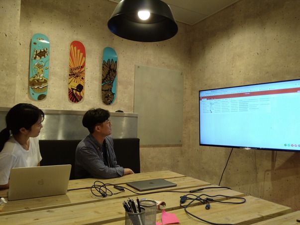 Eunae and Gyumin working on the database schema together in a meeting room